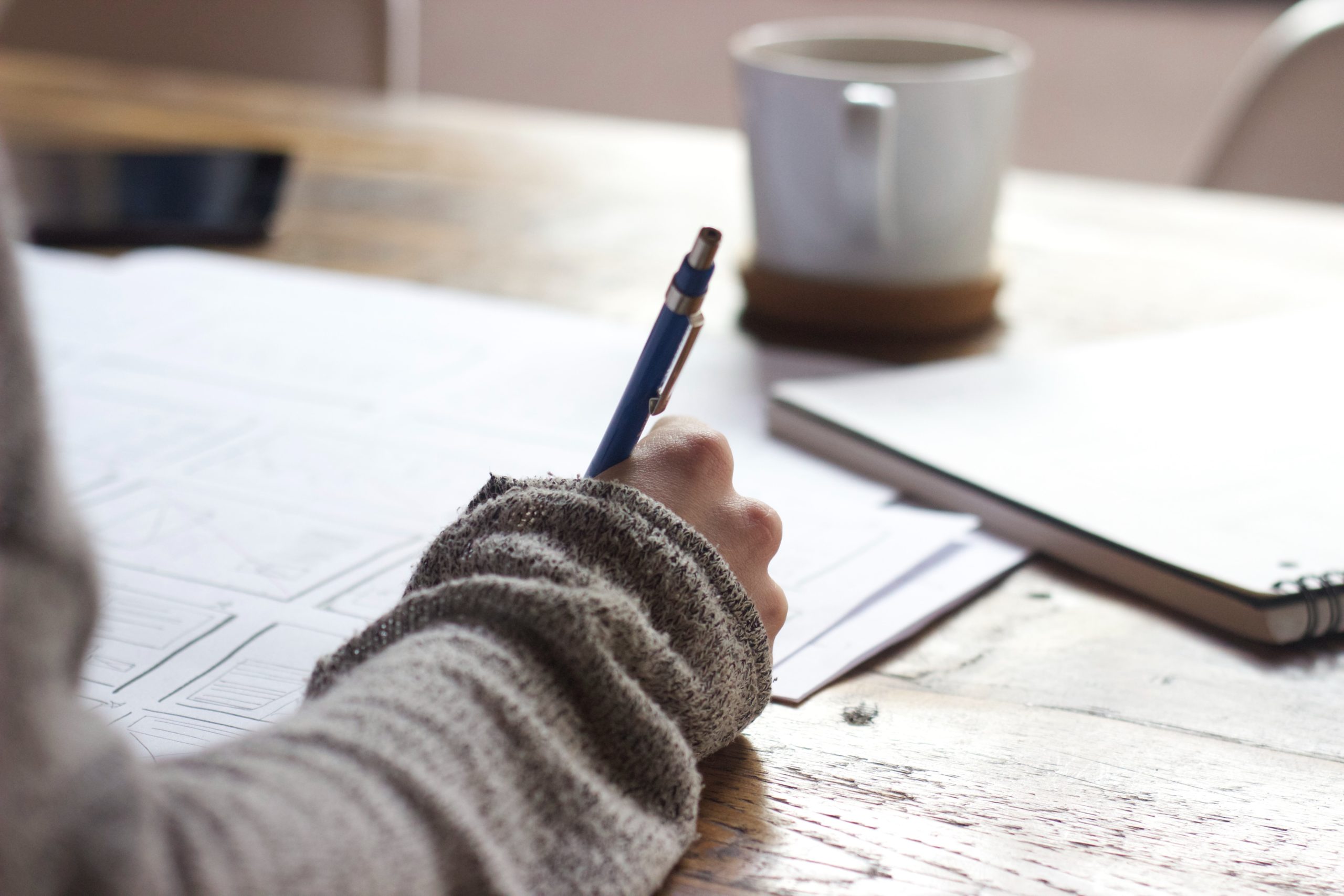 Wake up early context, woman writing on paper with cup of coffee