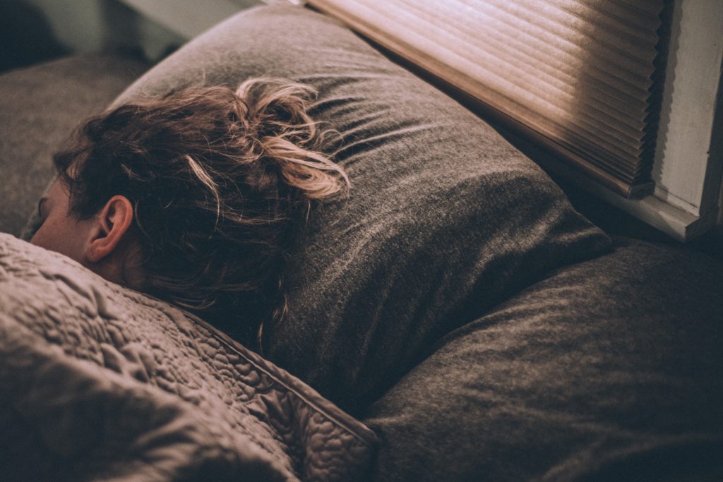 Chronic illness context, woman asleep with head on pillow