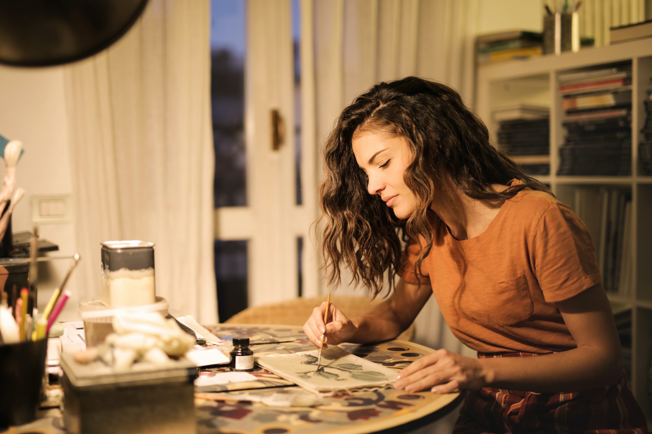 Product-based business context, woman painting at a desk