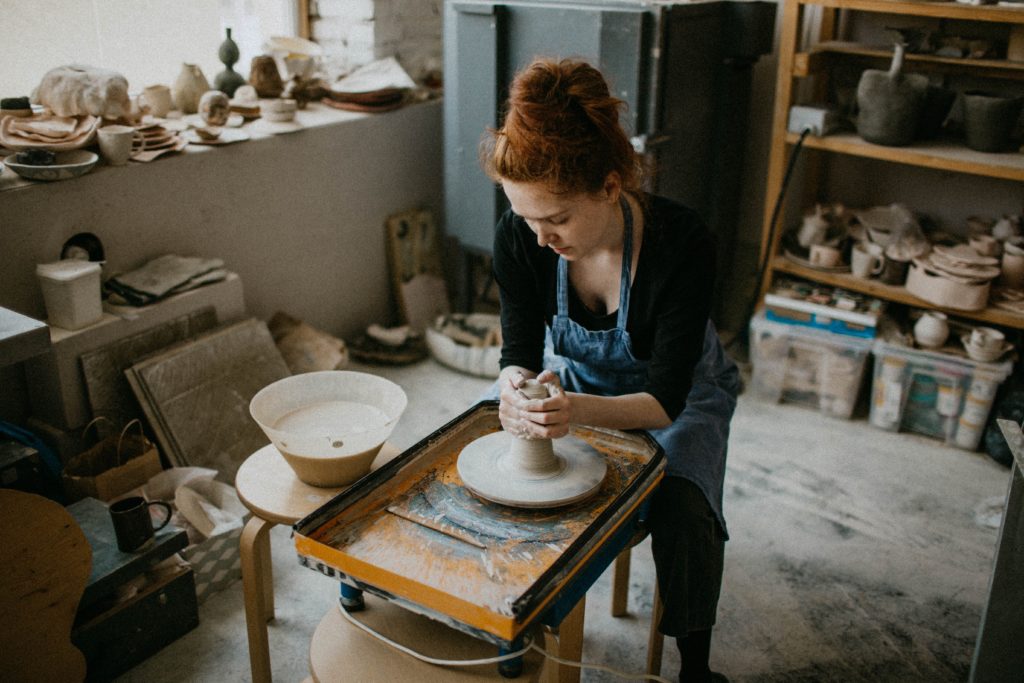 Product-based business context, woman making pottery in a pottery studio